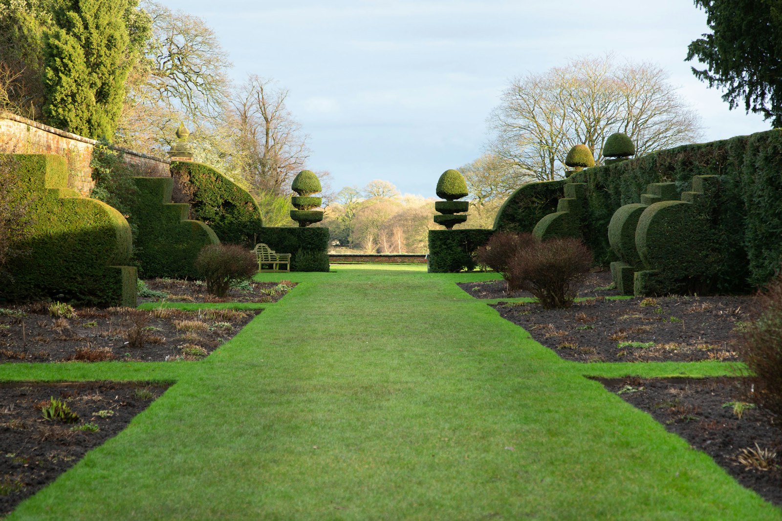 Long manicured green lawn with mature pine and oak trees — typical Montgomery County property.